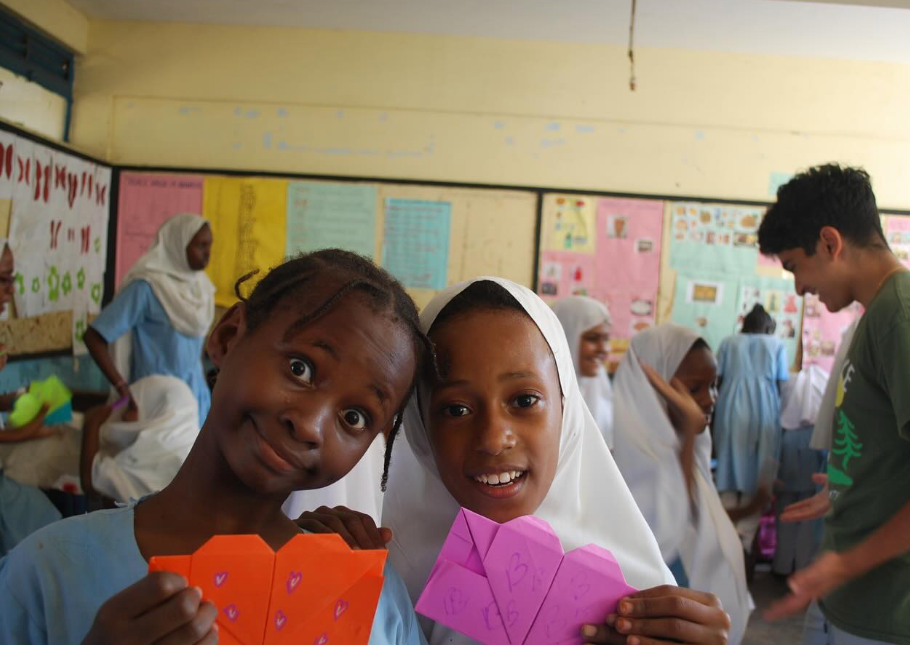 Students at Central Girls Primary School in Mombasa, Kenya holding handmade heart envelopes