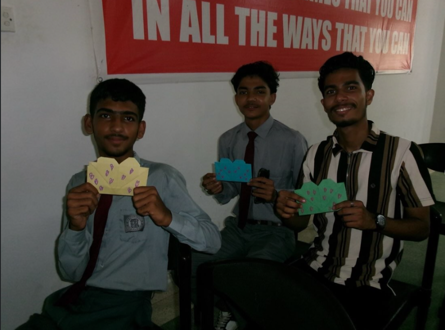 Volunteers presenting HeartPack letters at IDA Rieu School